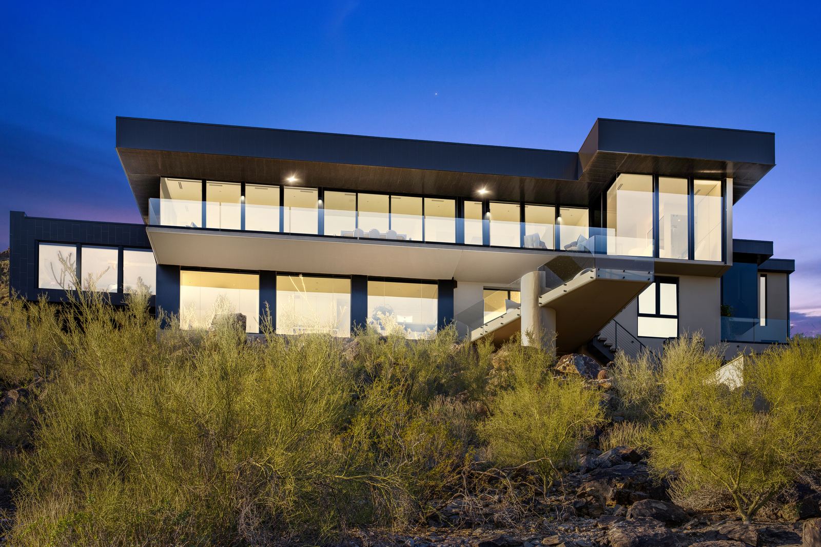 Twilight conversion of a modern house exterior after