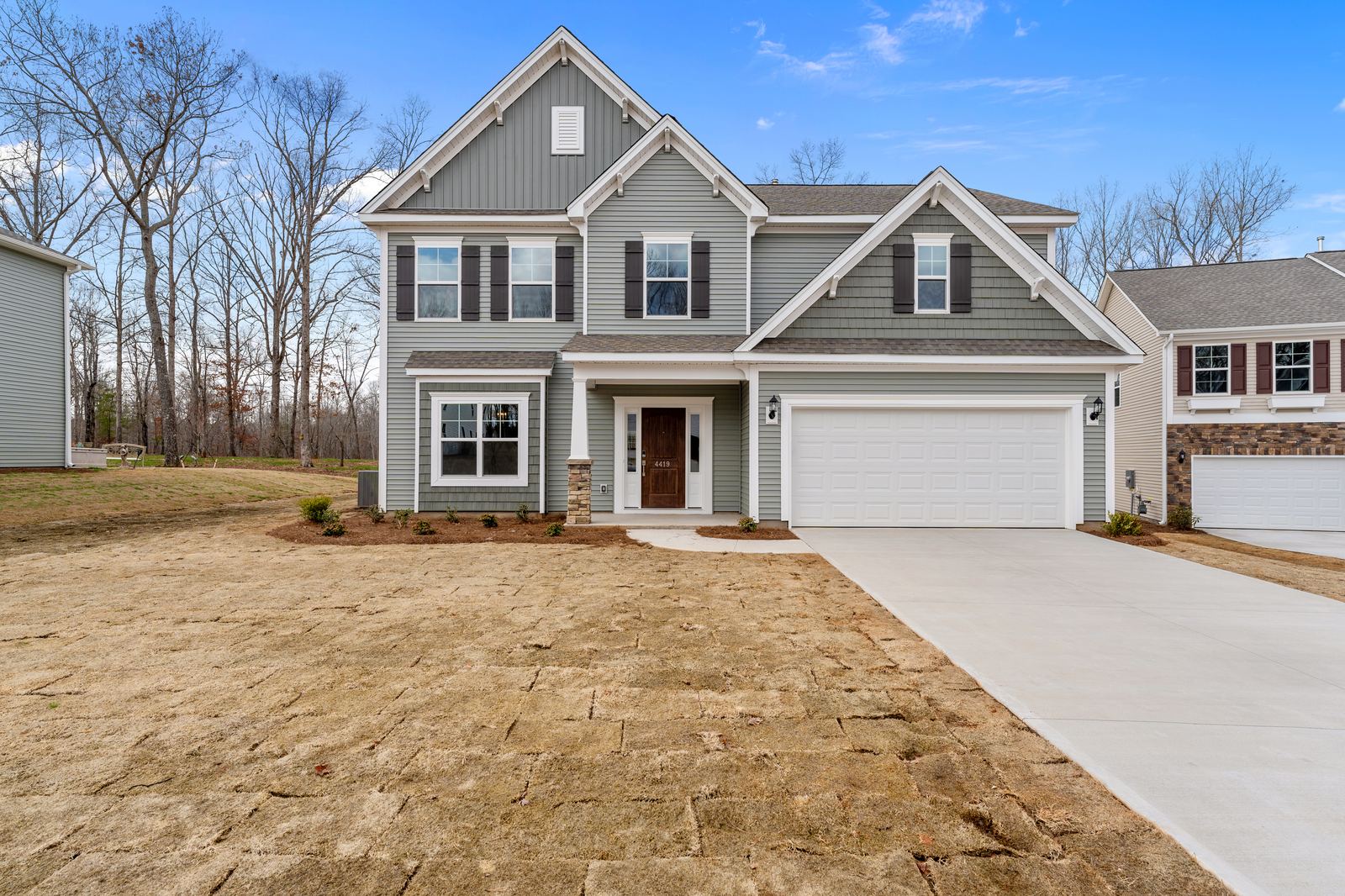 High-end manual real estate photo editing of a home exterior after
