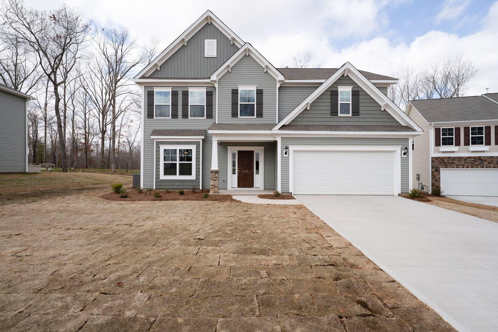 High-end manual real estate photo editing of a home exterior before